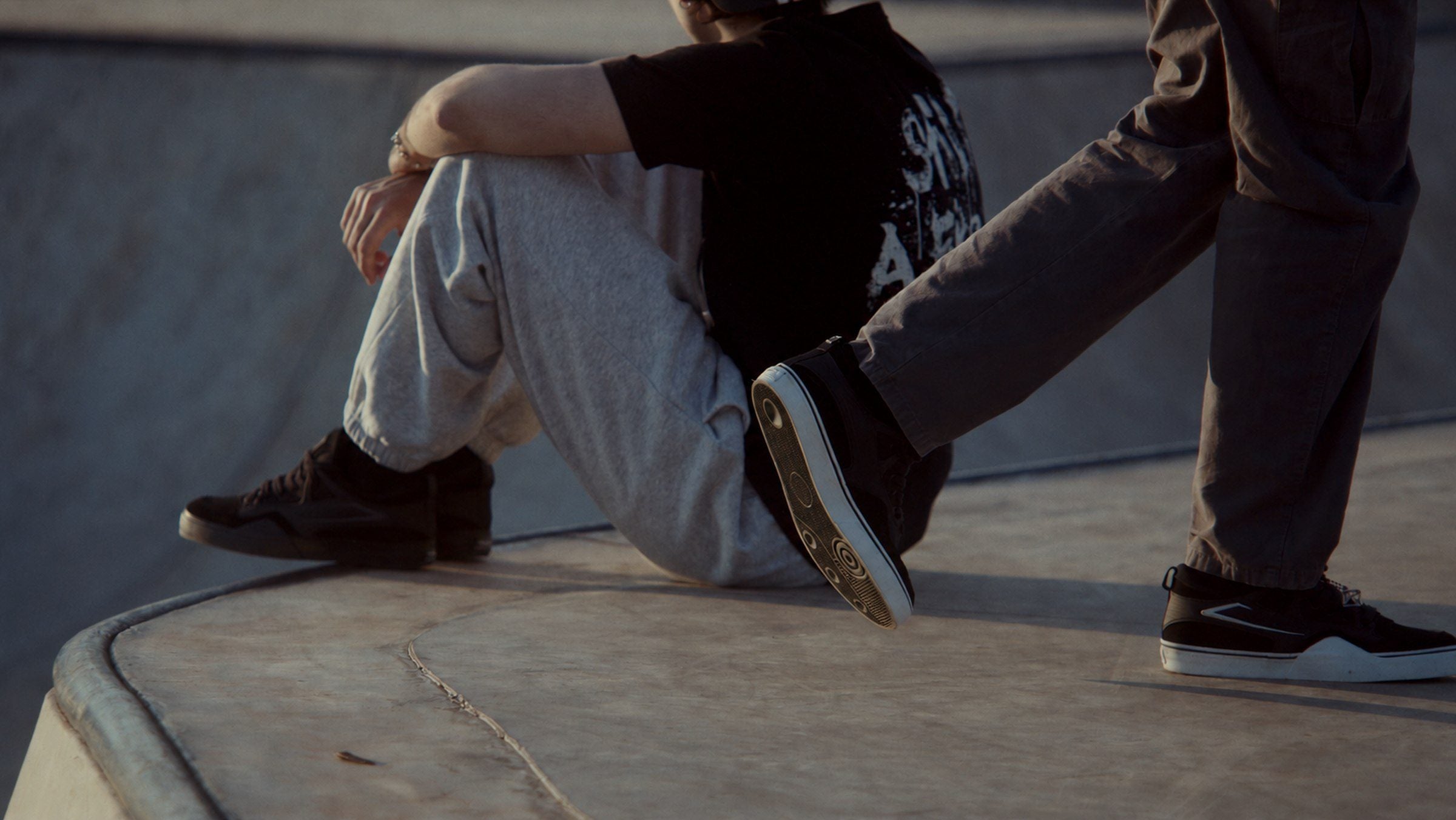 Dois garotos com tênis SKWER Frame na pista de skate